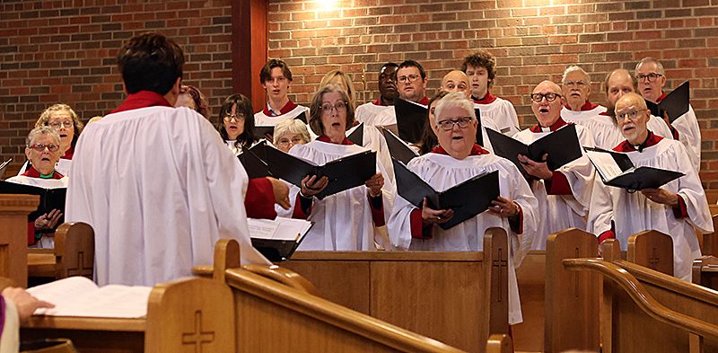 A woman directs a church choir