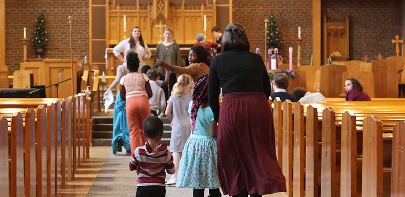 children-walking-up-church-aisle