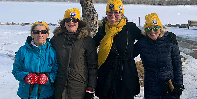 4 women on a cold day out doing community outreach